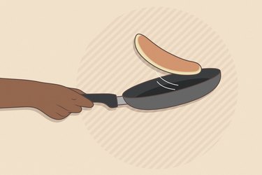 illustration of a persons hand flipping a pancake in a non-stick pan